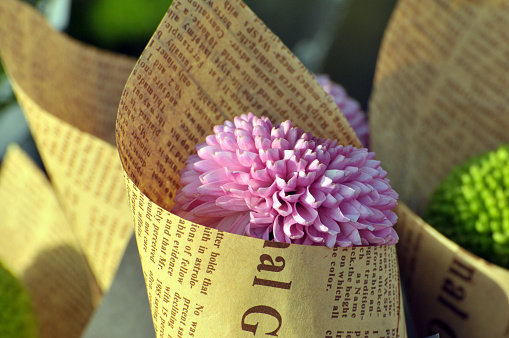 A lot of beautiful Bouquets Of  chrysanthemum flowers Wrapped In newspaper in the flower market