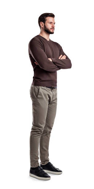 istock A young man in jumper and cargo pants stands looking in front in half-turned view with arms folded on his chest 1022920786