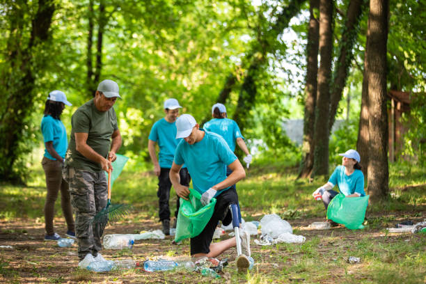 istock Young man with prosthetic leg cleaning the park 1022924810