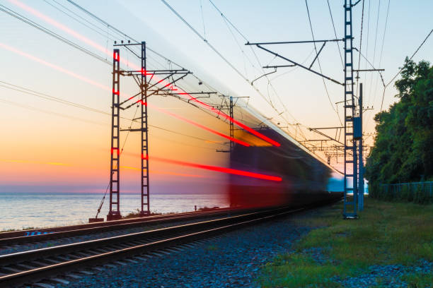istock Railroad with train on background of sea 1022928382