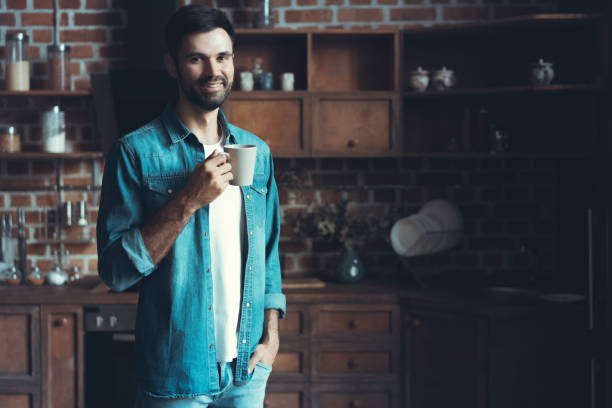 istock Happy man enjoying his coffee during a break in the kitchen. 1022937622