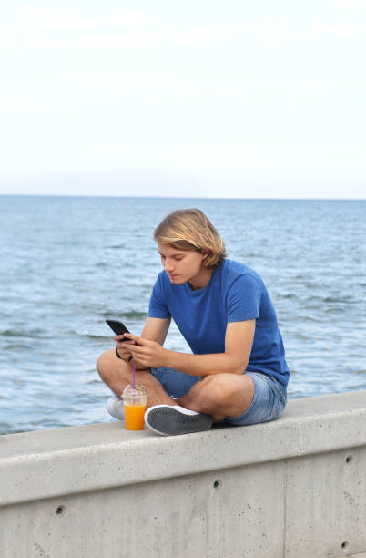 istock Teenage boy typing text message.Using smart phone. 1022942326
