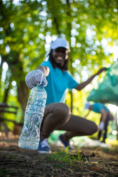 Black Man Picking Up Trash In Own Yard Black Man Picking Up Trash Stock Photos, Pictures & Royalty-Free Images