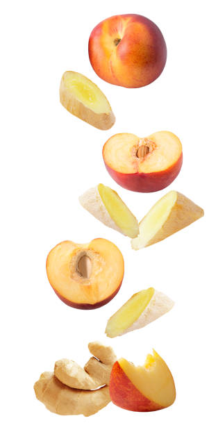 istock Flying fresh ginger and peaches isolated on white background 1022952082
