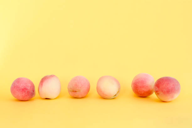 Whole ripe beautiful peaches in a row