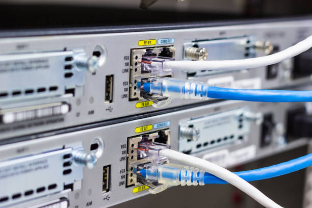 istock Network switch in rack, network cables connect SFP module port in the Data center room. 1022981430