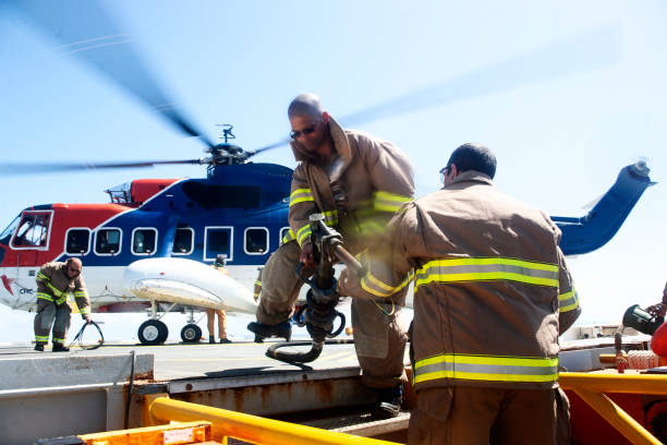 A KA-32 helicopter of the Ministry of Emergency Situations hovering over a lake from which water is drawn to extinguish a forest fire. In the background is a blue sky