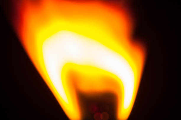 istock Close up of flame from lighter isolated on black background 1022985808