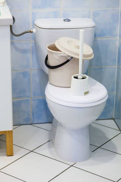 istock Toilet with brush and trash 1022986240