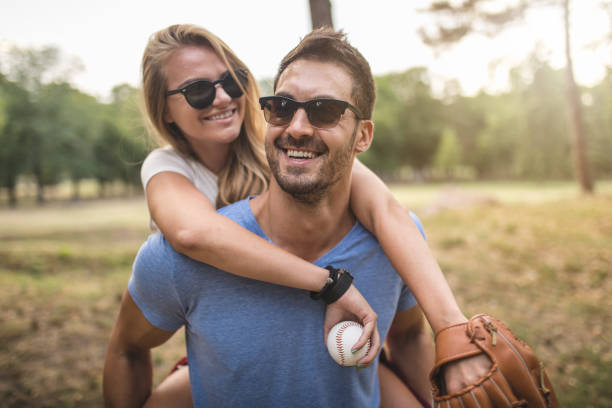 istock Handsome boyfriend carrying his girlfriend on his back in a park 1022999110