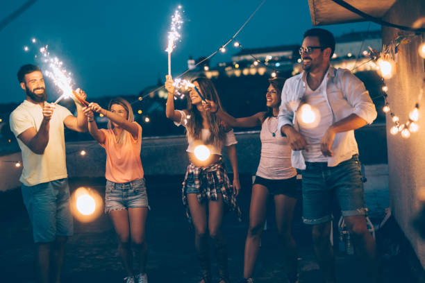 istock Group of happy friends celebrating at rooftop 1022999828