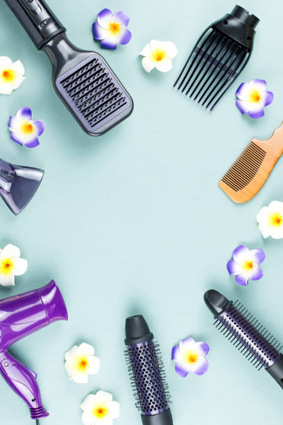 hairdressing tools with flowers on blue wooden background - 2042 imagens e fotografias de stock