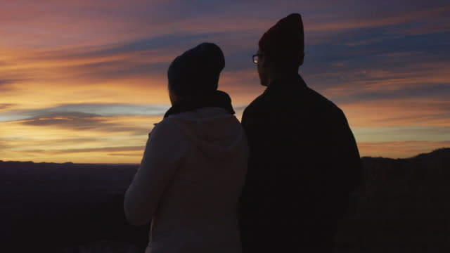 Young couple watching the sun rise