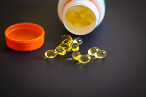 close-up of fish oil pills - fish oil vitamin e cod liver oil nutritional supplement imagens e fotografias de stock