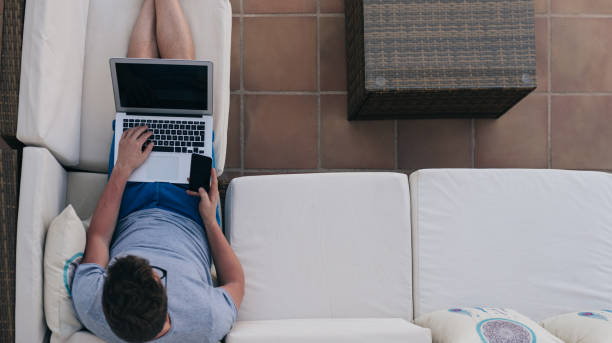 istock Man working from home at the yard on his computer 1023022234