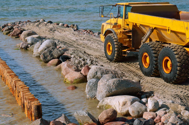 istock coastal protection measures, construction equipment on the shore, the construction of breakwaters 1023022318