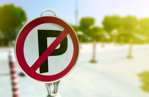 istock No parking sign board with blurred background 1023026604