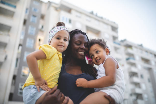 istock Gorgeous mother holding her mixed-race children 1023034912