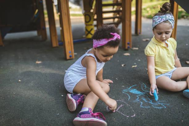 istock Lovely children playing and drawing on a playground 1023039184