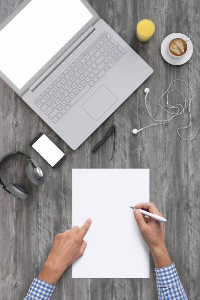 Man writing on a blank piece of paper, copy space template - top view