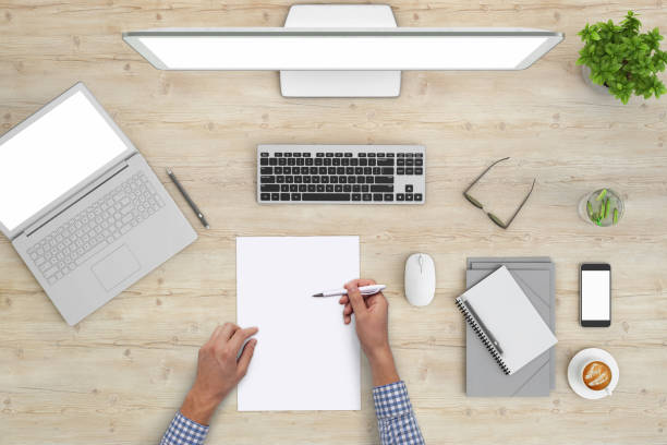 istock Man writing on a blank piece of paper, copy space template - top view 1023042528