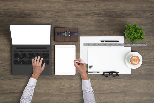 istock Man working on a laptop knolling overhead view 1023042548