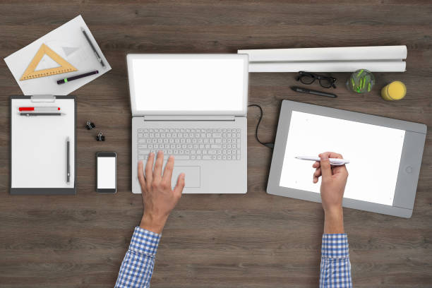 istock Architect designer working on office desk knolling overhead view 1023042590