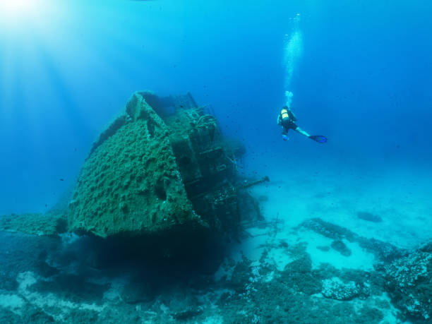 istock Scuba diver is exploring a sunken wreck 1023049884