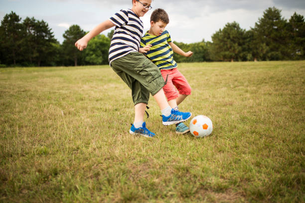 istock Little boys playing football 1023049914