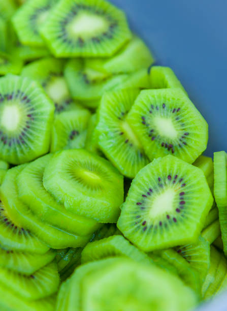 istock Closeup of Fresh Kiwi Fruit Slices in a Blue Container 1023063164