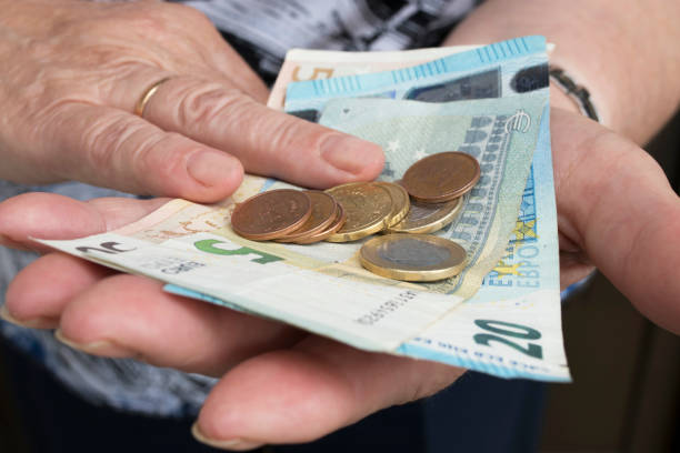 istock older people's hands with cash 1023066740