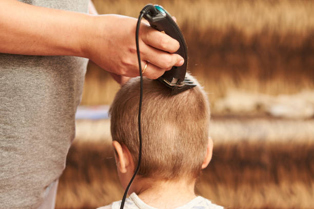 istock A man cuts machine child at home. 1023073830