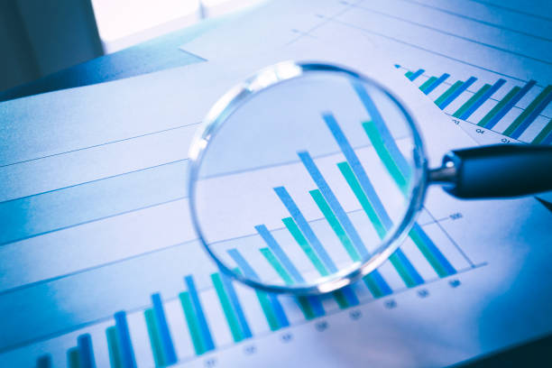 istock Magnifying Glass On Top Of Bar Chart 1023104812