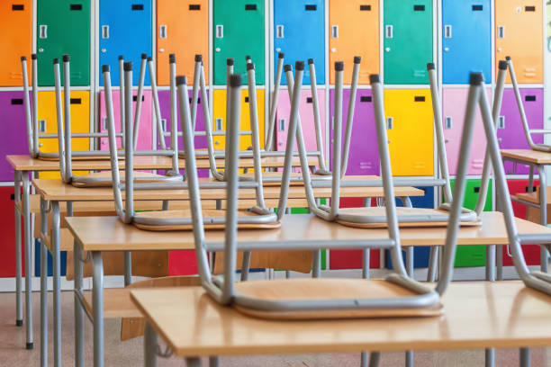 istock Classroom with colorful lockers and raised chairs on the tables 1023111494