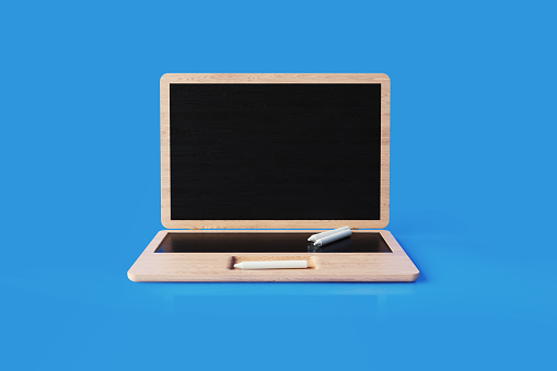 Laptop shaped blackboard isolated on blue background. Horizontal composition with copy space. Great use for learning concepts.