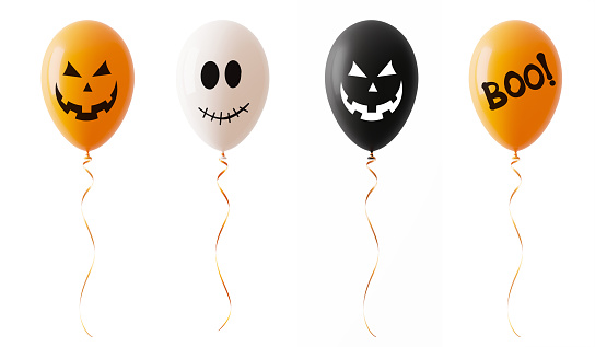 Orange white and black colored Halloween balloons with spooky faces isolated on white background. Horizontal composition with copy space. Clipping path is included.