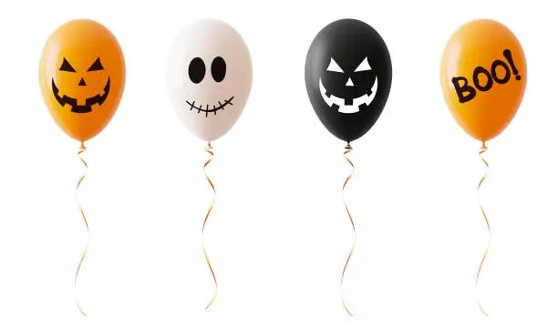 Photo of Orange White And Blacked Colored Halloween Balloons With Spooky Faces Isolated On White Background