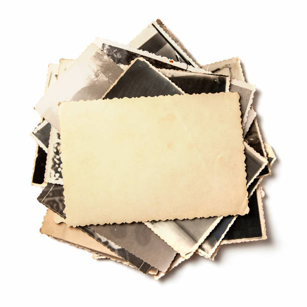 istock Stack old photos isolated on white background. Mock-up blank paper. Postcard rumpled and dirty vintage 1023112568