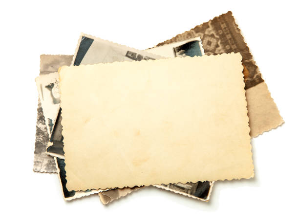 istock Stack old photos isolated on white background. Mock-up blank paper. Postcard rumpled and dirty vintage 1023112582