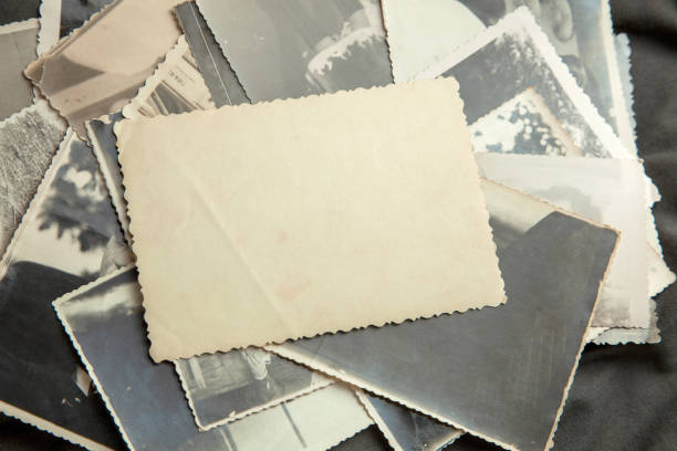 istock Stack old photos on table. Mock-up blank paper. Postcard rumpled and dirty vintage 1023112602