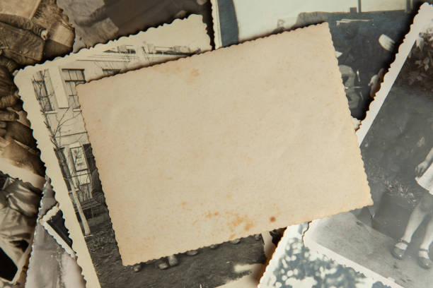 istock Stack old photos on table. Mock-up blank paper. Postcard rumpled and dirty vintage 1023112640