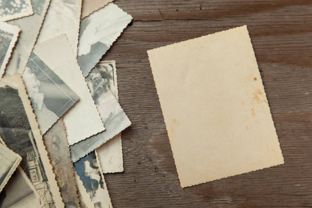istock Stack old photos on table. Mock-up blank paper. Postcard rumpled and dirty vintage 1023112678