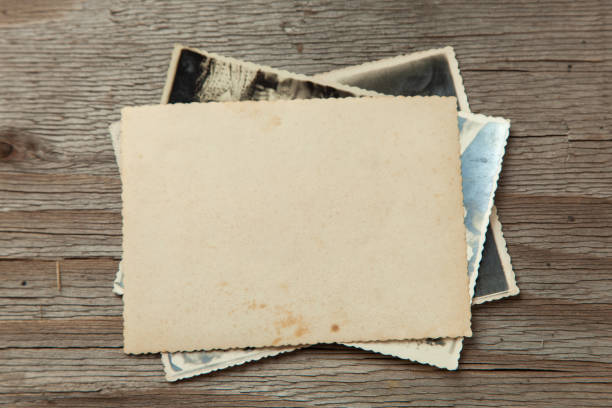 istock Stack old photos on table. Mock-up blank paper. Postcard rumpled and dirty vintage 1023112686