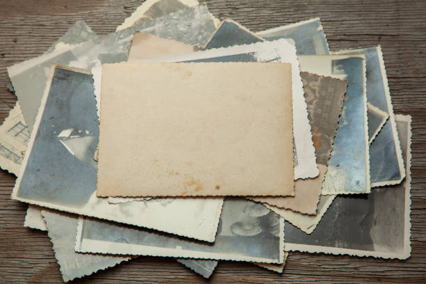 istock Stack old photos on table. Mock-up blank paper. Postcard rumpled and dirty vintage 1023114824