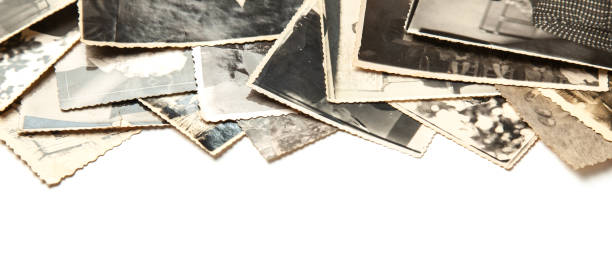 istock Stack old photos isolated on white background. Postcard rumpled and dirty vintage 1023114846