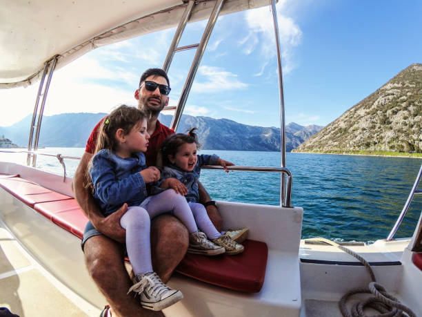 istock Young father with adorable daughters on a big boat 1023114886