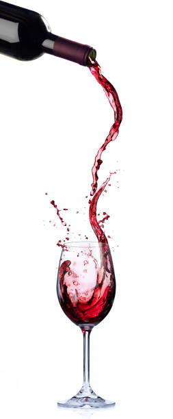 wine in motion and splashing in wineglass - garrafa de tinto imagens e fotografias de stock
