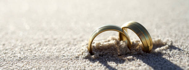 Wedding rings at the beach stock photo