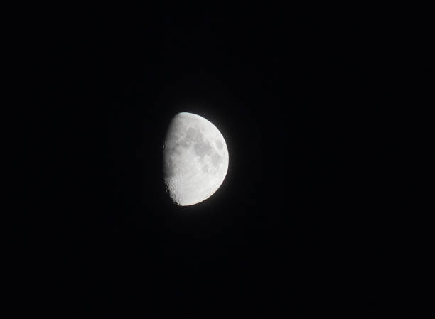 istock silver bright half moon in a black sky showing seas and craters in shadow 1023127450