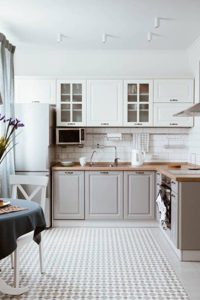 istock Scandinavian interior design. White grey kitchen room organization 1023127516